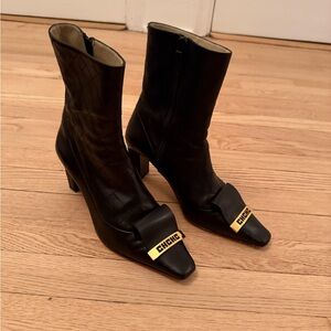 Carolina Herrera Elegant Black Heeled Boots with Gold Accents